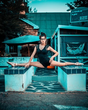 Photo of Ballerina Doing 180 Split on Stone Blocks