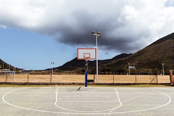 Photo of Basketball Court Under Cloudy Sky