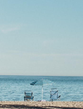 Photo of Beach Chairs On Seashore