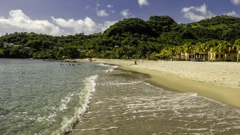 Photo of Beach Near Green Mountain Under Cloudy Sky