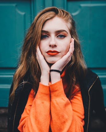 Photo of Beautiful Woman Holding Both Cheeks