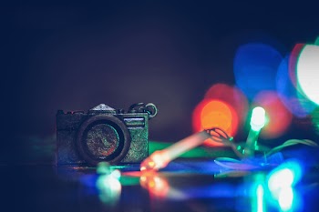 Photo of Black Camera Near Green and Red Strip Lights