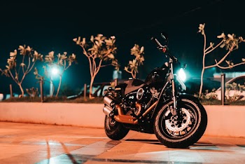 Photo of Black Motorcycle Parked On Pavement