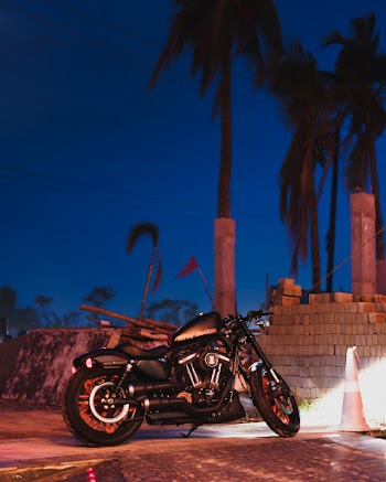 Photo of Black Motorcycle Parking Near Cinder Blocks at Night