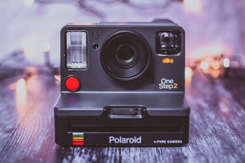 Photo of Black Polaroid Onestep 2 Camera on Gray Surface