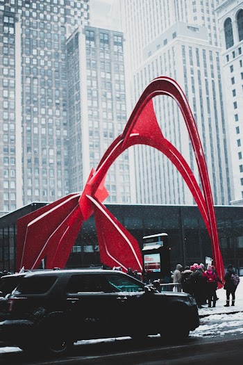 Photo of Black SUV Car Next to Calder's Flamingo Stabile  in Chicago