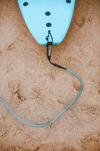 Photo of Blue Surfboard With Leash on Sand