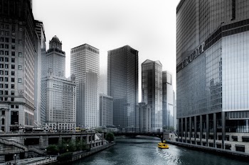 Photo of Boat Going Through River in Between Highrise Buildings