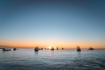 photo of boats under clear blue sky