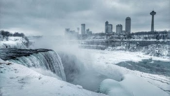photo of body of water covered by snows