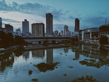 Photo of Body of Water Near Concrete Buildings 