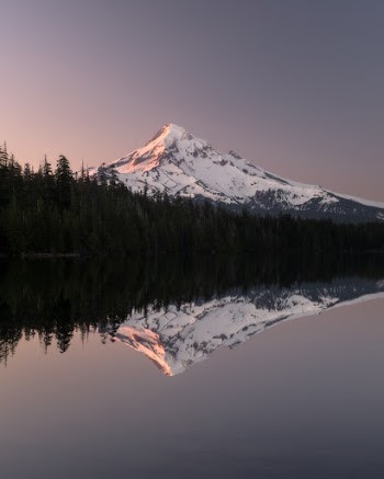 Photo of Body of Water Near Snowy Mountain