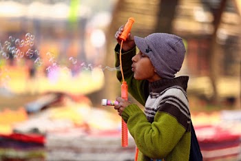 Photo of Boy Blowing Bubbles