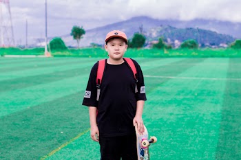 Photo of Boy Holding Skateboard