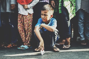 Photo of Boy Holding White Smartphone