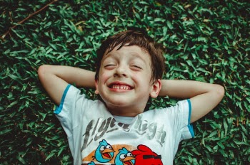 Photo of Boy Laying On Grass