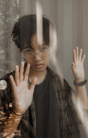 Photo of Boy Leaning On Glass