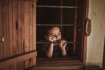 Photo Of Boy Leaning On Window Rails