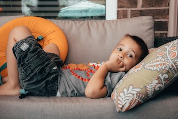Photo of Boy Lying on Sofa