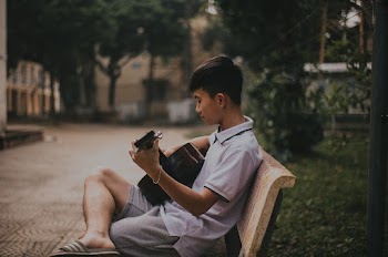 Photo of Boy Playing Guitar