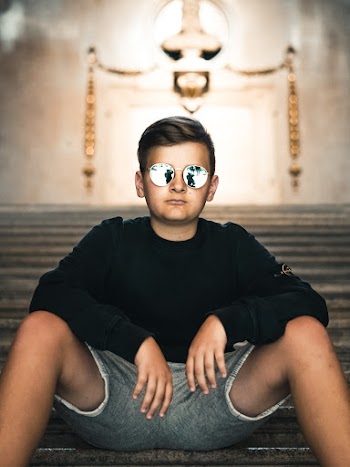Photo of Boy Sitting on Stairs