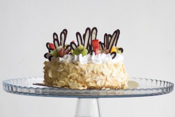 Photo of Brown and White Icing Covered Cake With Kiwi