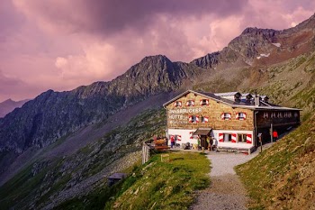photo of brown house on cliff