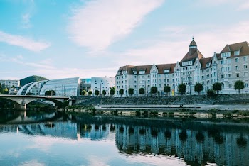 Photo of Buildings Near Trees and River