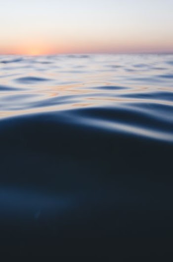 photo of calm sea water during daytime