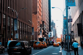 Photo of Cars on Road Near Buildings