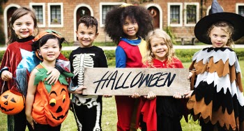 Photo of children in Halloween Costumes Smiling
