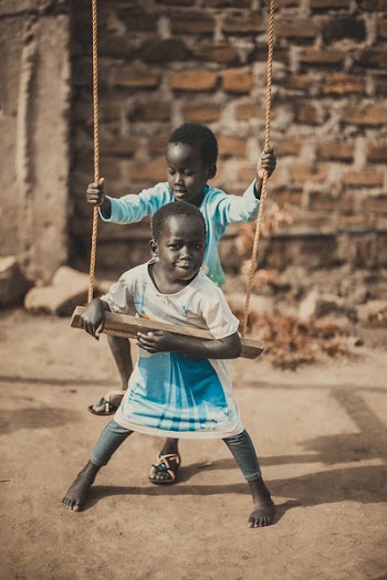 Photo of Children Playing on Swing