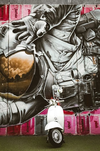 Photo of Classic Motorcycle In Front Of Graffiti