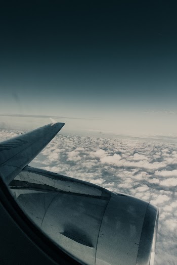 Photo Of Clouds Through An Airplane Window