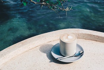 Photo of Coffee Cup Near Body of Water