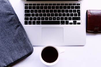 Photo of Coffee of Cup Near Laptop and Wallet