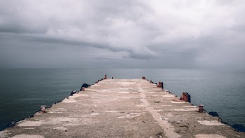 Photo of Concrete Dock Under Cloudy Sky
