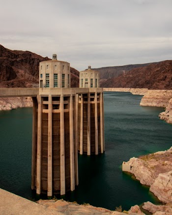 Photo of Concrete Towers on Body of Water