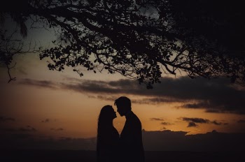 Photo of Couple Facing Each Other During Golden Hour