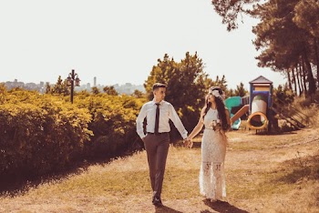 Photo of Couple Holding Hands While Walking