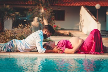 Photo Of Couple Lying Beside Pool