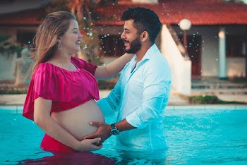 Photo of Couple Smiling and Standing by Each Other