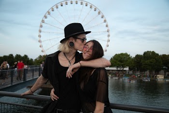 Photo of Couple Standing Near Metal Railings