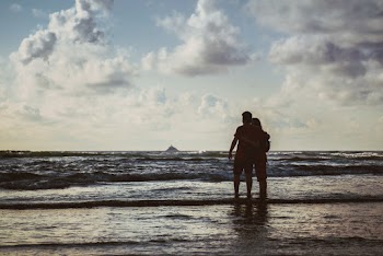 Photo of Couple Standing on Seashore