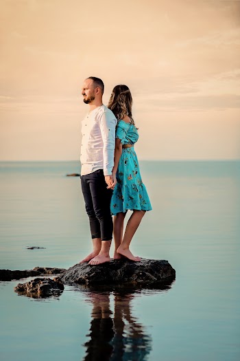 Photo Of Couple Standing On Top Of Rock