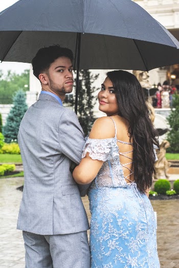 Photo of Couple Standing Under Umbrella