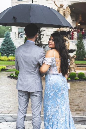 Photo of Couple Standing Under Umbrella