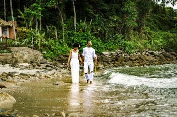 Photo of Couple Walking on Seashore