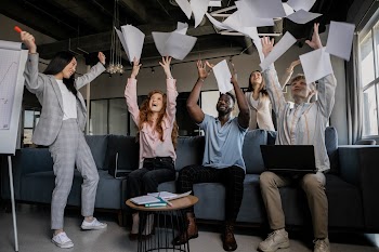 Photo of Coworkers Throwing Pieces of Paper · Free Stock Photo