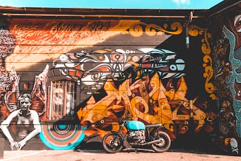 Photo of Cruiser Motorcycle Parked Near Graffiti Wall